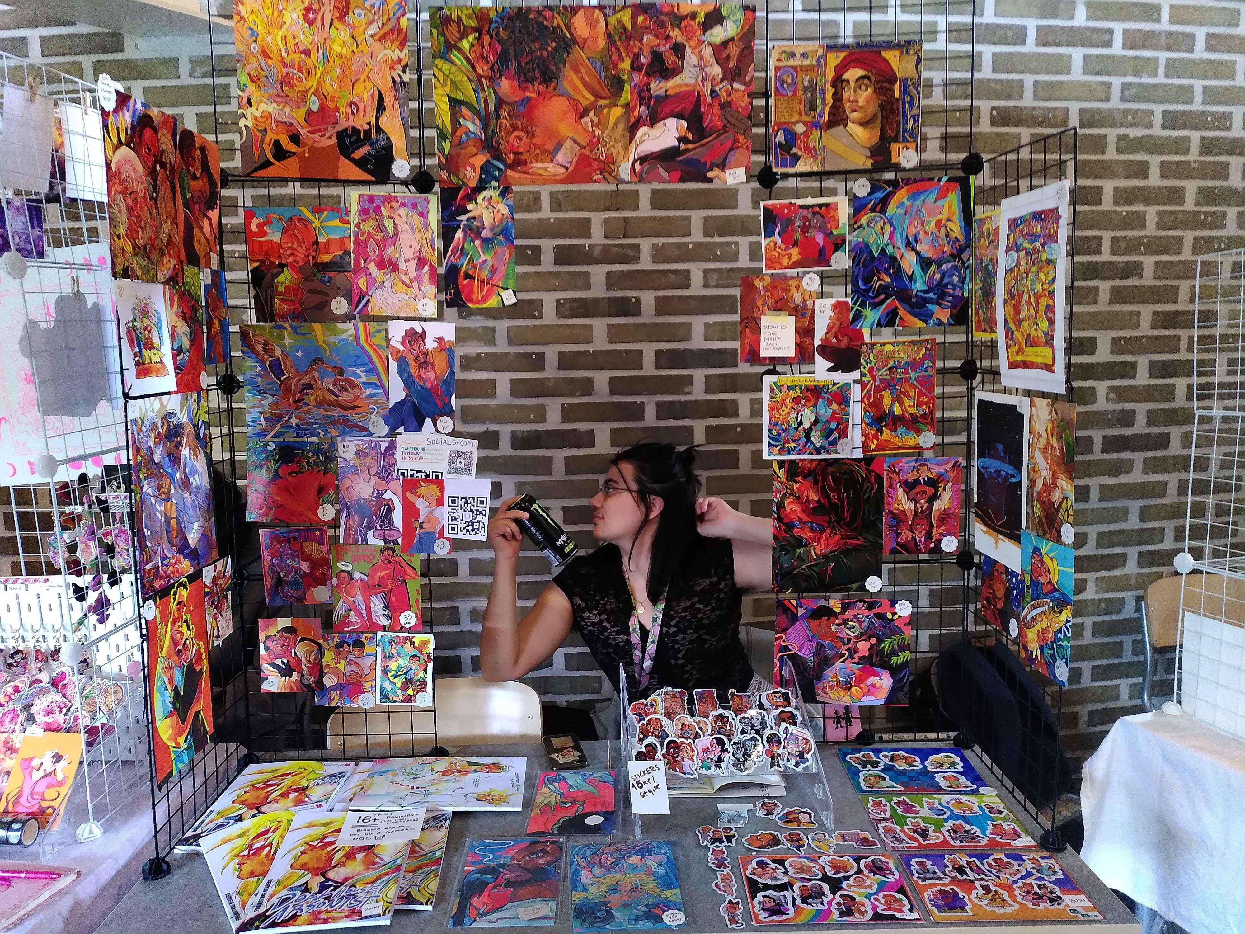 Convention table with prints and merchandise